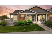 Charming single-story home with stone accents, landscaped front yard, and accessible ramp entrance at 12940 Jasmine St # A, Thornton, CO 80602