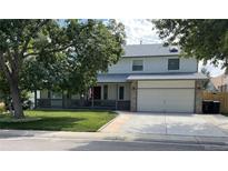 Charming two-story home with a welcoming front porch and well-maintained landscaping at 11978 W Aqueduct Dr, Littleton, CO 80127