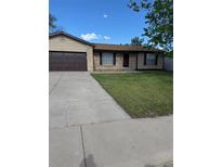 Charming ranch-style home featuring a well-maintained lawn and a two-car garage at 9134 Bellaire St, Thornton, CO 80229