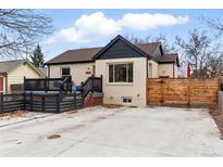 Well-maintained bungalow featuring a front porch, fresh paint, and modern fencing at 1678 Verbena St, Denver, CO 80220