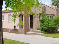 Charming home featuring an arched doorway, brick accents, and well-maintained landscaping at 3739 W 46Th Ave, Denver, CO 80211
