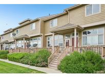 Inviting townhome exteriors boast covered front porches, manicured landscaping, and a warm, welcoming atmosphere at 9770 Dahlia Ln, Thornton, CO 80229