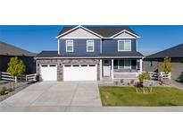 Charming two-story home with a stone accent, a well-manicured lawn, and a three-car garage at 4851 Cattle Cross Rd, Castle Rock, CO 80104