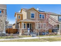 Charming two-story home featuring a covered front porch, stone accents, and a well-maintained lawn at 7367 S Pennsylvania St, Littleton, CO 80122
