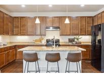 Beautiful kitchen featuring stainless steel appliances, granite countertops, and a central island with barstool seating at 7367 S Pennsylvania St, Littleton, CO 80122