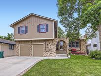 Two-story home with brick and stucco, featuring an arched brick entryway and a well-manicured lawn at 9150 Garrison St, Broomfield, CO 80021