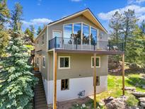 Stunning two-story home featuring a spacious balcony and beautiful natural surroundings at 22155 Cook Ln, Morrison, CO 80465