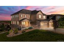 Beautiful two-story home with a three car garage and a covered porch at 7606 S Valleyhead Ct, Aurora, CO 80016