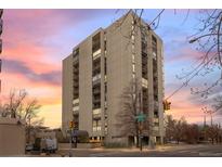 A tall building with symmetrical architecture rises with balconies and a crosswalk in front at 777 N Washington St # 304, Denver, CO 80203