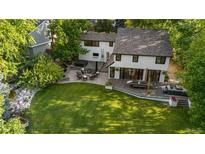 Expansive backyard featuring a patio, hot tub, and lush green lawn, perfect for outdoor entertaining and relaxation at 3235 E Easter Pl, Centennial, CO 80122