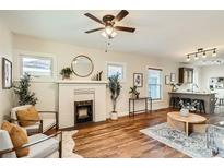 Bright, open-concept living area featuring hardwood floors and a fireplace at 2421 Hooker St, Denver, CO 80211