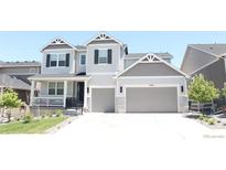 Charming two-story home with a two-car garage and a well-manicured front yard at 4792 Coltin Trl, Castle Rock, CO 80104