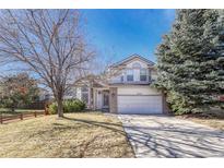 Charming two-story home with a well-manicured front yard and a two-car garage at 16350 Hedgeway Dr, Parker, CO 80134