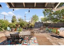 Spacious backyard deck with outdoor furniture, grill, and beautiful landscaping for entertaining at 1568 S Osceola Way, Denver, CO 80219