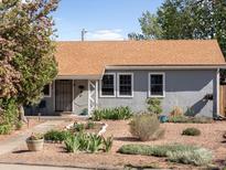 Charming single-story home featuring a well-kept landscaped yard with gravel, plants, and inviting curb appeal at 1568 S Osceola Way, Denver, CO 80219