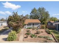 Charming single-story home with drought tolerant landscaping and a welcoming walkway leading to the front door at 1568 S Osceola Way, Denver, CO 80219