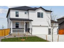 Charming two-story home with a manicured front yard and a two-car garage on a sunny day at 13802 Quartz St, Mead, CO 80504