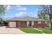 Charming brick home with well-maintained lawn, attached garage and mature trees at 2792 S Stuart St, Denver, CO 80236