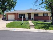 Charming single-story home featuring a brick facade, well-maintained lawn, and a welcoming front entrance at 2792 S Stuart St, Denver, CO 80236