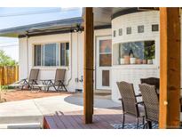 Inviting front porch with seating area and unique brickwork, perfect for relaxing outdoors at 4647 W Dakota Ave, Denver, CO 80219