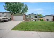 Charming single-Gathering home featuring a well-maintained lawn, mature trees, and an attached two-car garage at 10462 Hoyt St, Westminster, CO 80021