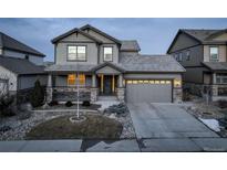 Two-story house with gray siding, stone accents, and a two-car garage at 13717 Ashgrove Cir, Parker, CO 80134