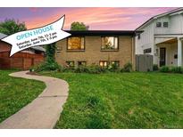 Charming brick home with a well-manicured lawn, inviting walkway, and an open house banner at 1111 Monroe St, Denver, CO 80206