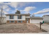 Charming two-story home with blue shutters, a brick foundation, and a two car garage at 16333 E Carolina Dr, Aurora, CO 80017