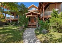 Inviting home exterior features a covered front porch, lush landscaping, and a charming walkway at 4880 Tall Horse Trl, Sedalia, CO 80135