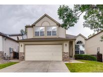 Charming two-story home featuring a neutral color scheme, an attached two-car garage and stone accents at 2792 S Ceylon St, Aurora, CO 80013