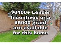 Charming single-story brick home with well-maintained lawn and inviting front porch at 3667 Hudson St, Denver, CO 80207