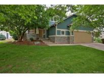 Charming two-story home with a well-maintained front yard and a cozy covered porch at 2500 Lexington St, Lafayette, CO 80026