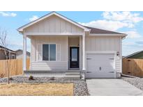 Charming single Gathering home with white siding, a covered porch, and an attached one-car garage at 5913 Sawdust Dr, Brighton, CO 80601