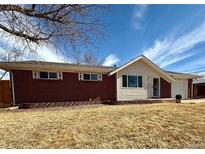 Charming single-story home with a brick exterior and well-maintained front yard at 5986 S Cook St, Littleton, CO 80121