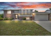 Charming brick home with a well-manicured lawn, two-car garage, and inviting entrance at 8759 Seton St, Westminster, CO 80031