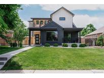 Striking home boasts a modern design with black brick, wood accents, and a charming balcony at 2645 Eudora St, Denver, CO 80207