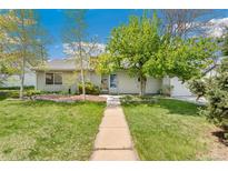 Charming single-story home features a well-maintained lawn, mature trees, and a welcoming walkway to the front door at 3485 S Forest St, Denver, CO 80222