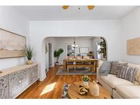 Inviting living room and dining room area features hardwood floors, tasteful decor, and plenty of natural light at 4518 Vallejo St, Denver, CO 80211