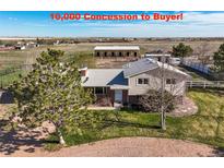 Expansive exterior view of the 2 story home on a lot with mature trees and a large outbuilding at 29881 E 128Th Ave, Commerce City, CO 80022