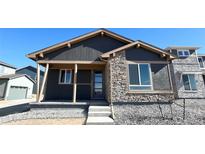 Charming single-Gathering home featuring a stone facade and covered front porch at 2263 Serenidad St, Brighton, CO 80601