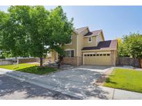 Charming two-story home with a well-maintained lawn and a two-car garage, perfect for suburban living at 6260 E 114Th Ave, Thornton, CO 80233