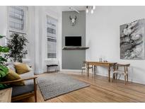 Inviting living room featuring hardwood floors, stylish decor, and large windows offering ample natural light at 720 16Th St # 311, Denver, CO 80202