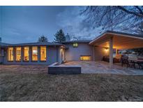 Spacious backyard patio with an outdoor kitchen and dining area perfect for entertaining guests and relaxation at 2605 Crabapple Ct, Golden, CO 80401
