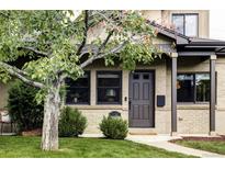 Charming brick home featuring a well-manicured lawn and freshly painted door and trim at 1272 S Milwaukee St, Denver, CO 80210
