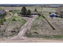 Picturesque property featuring a long driveway leading to a charming home and outbuildings on a spacious lot at 7605 Shenandoah Dr, Elizabeth, CO 80107