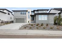 Modern two-story home featuring a stylish stone facade, attached garage, and well-maintained landscaping at 455 Rogers Way, Castle Rock, CO 80104