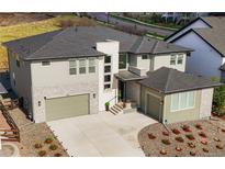 Stunning, modern home with a three-car garage, stone accents, and manicured landscaping for great curb appeal at 455 Rogers Way, Castle Rock, CO 80104