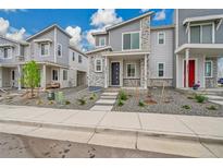 Modern townhome showcases a gray exterior with stone accents and well-kept landscaping at 4612 S Wenatchee St # A, Aurora, CO 80015
