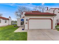 Charming home featuring a red tile roof, two car garage and landscaped front yard at 1236 Sequerra St, Broomfield, CO 80020