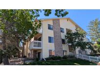 Multi-level condo building with brick accents, balconies, and well-maintained landscaping at 12506 E Cornell Ave # 201, Aurora, CO 80014
